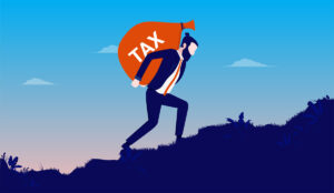 Tax problem - Man walking up steep hill struggling with big sack of money.